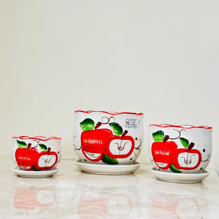 Indoor and outdoor apple-themed ceramic planters with trays