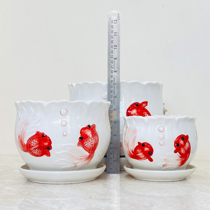 Set of three ceramic planters with red fish illustrations