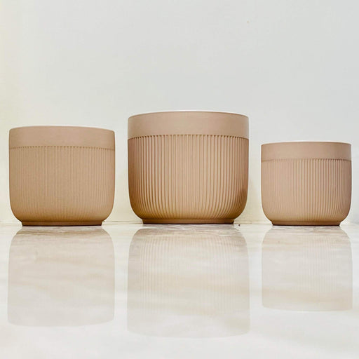 Beige ceramic planter set with vertical ridges