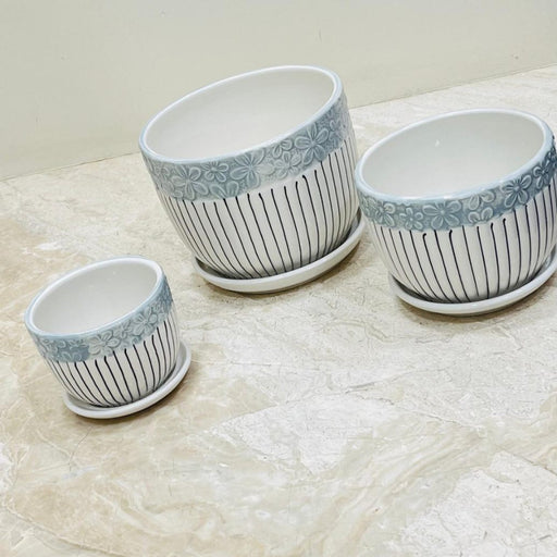 Blue bloom ceramic pot set with floral rim and vertical stripes