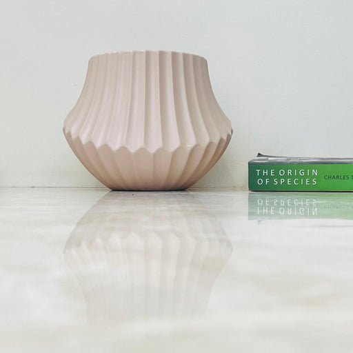 Blush pink ribbed ceramic planter with flared design