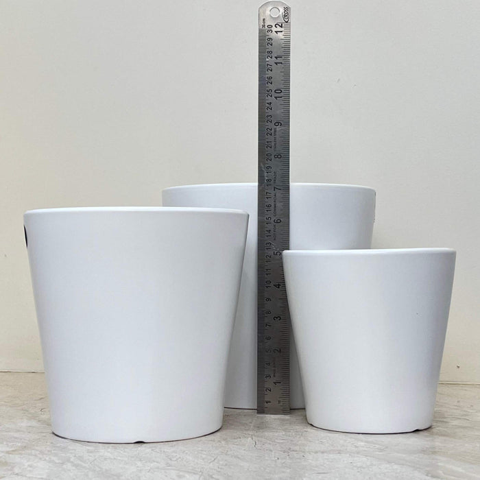 White ceramic plant pots with a sleek matte finish