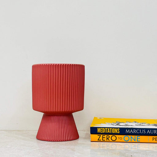 Coral red ceramic plant pot with ribbed texture