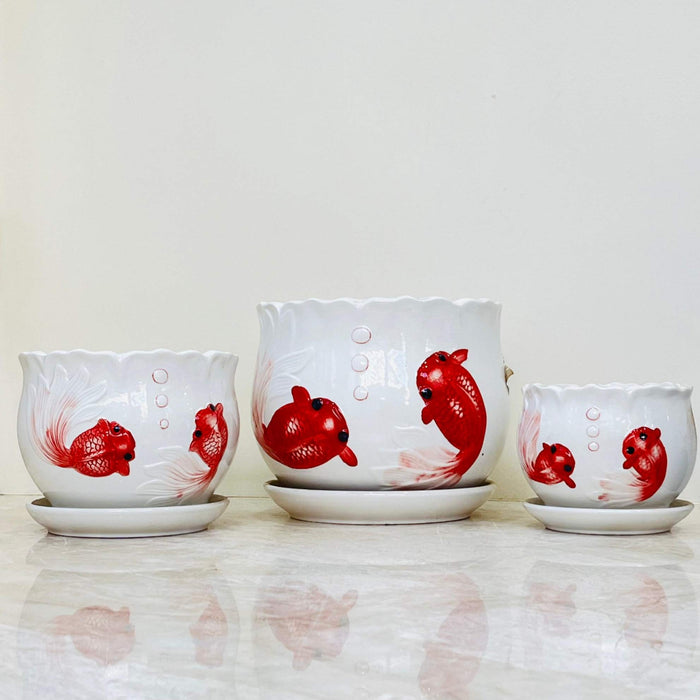 Artistic white pots with red fish motif and scalloped edges