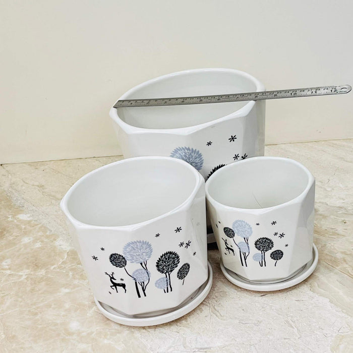 Set of white ceramic pots with matching saucers and deer design