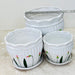 Decorative white ceramic pots with floral pattern and elegant rim