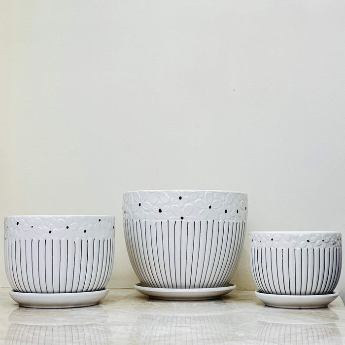 Trio of elegant ceramic pots with floral texture and stripe accents