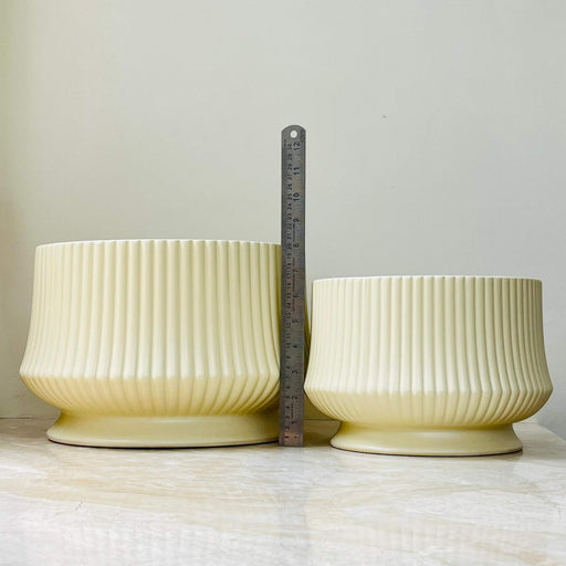 Elegant fluted ceramic plant pots in beige