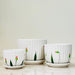 Elegant fluted ceramic pots with floral details