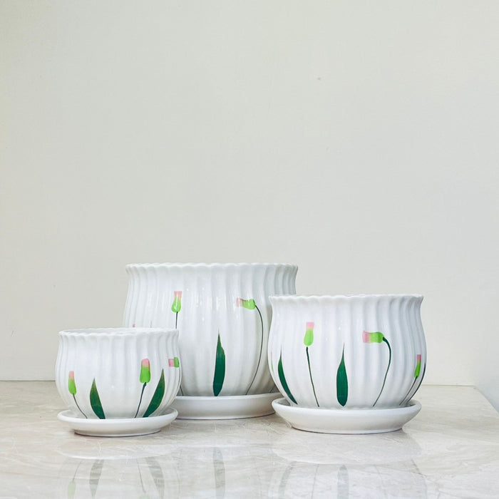 Hand-painted floral ceramic planters with matching saucers