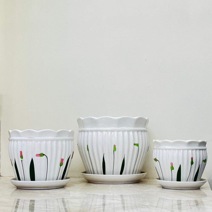 Stylish white ceramic planters with delicate pink and green floral accents