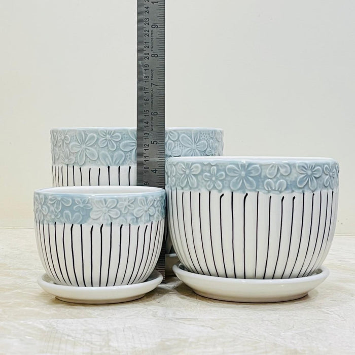 Three-piece ceramic planter set with matching saucers