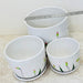 Decorative white ceramic pots featuring pink bud designs and green stems