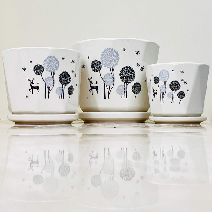 White ceramic pots with forest and deer design