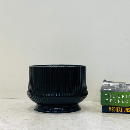 Glossy black ribbed ceramic planter for indoor plants