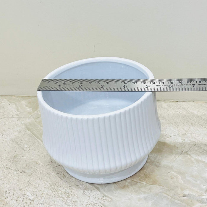 Glossy white ceramic pot with ribbed design