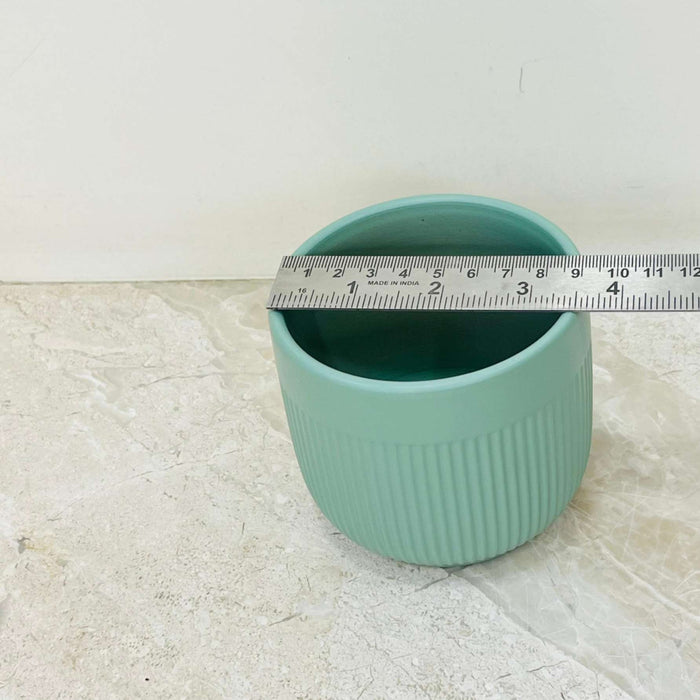 Medium-sized green ceramic pot with ribbed texture