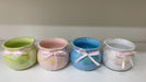 High-gloss ceramic pot with ribbon in pastel colors