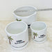 Decorative white pots with palm tree and matching saucers