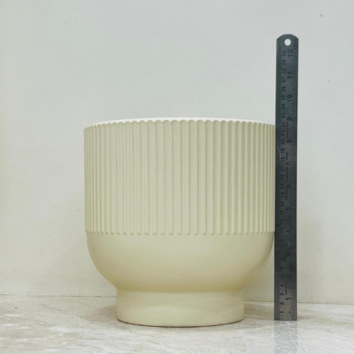 Beige ceramic plant pots with vertical ribbed texture