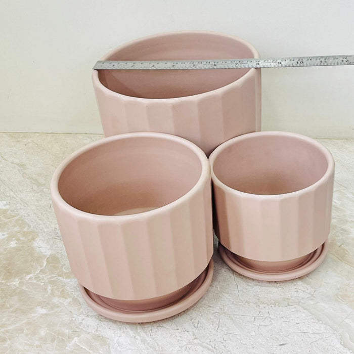 Three-piece beige ceramic planters with a modern look