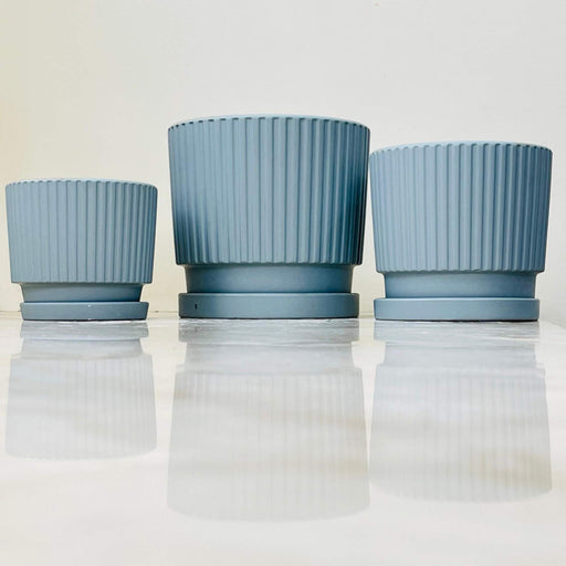 Ribbed blue ceramic planters with matching saucers