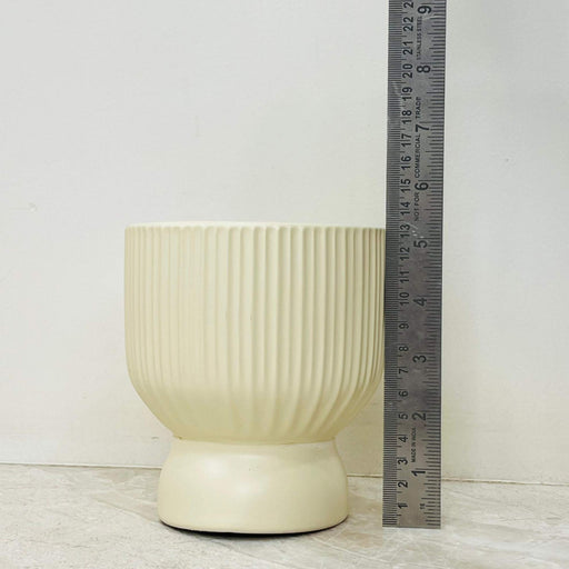 Matte ivory ceramic planter with ribbed texture