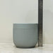 Medium gray ceramic plant pot with vertical texture