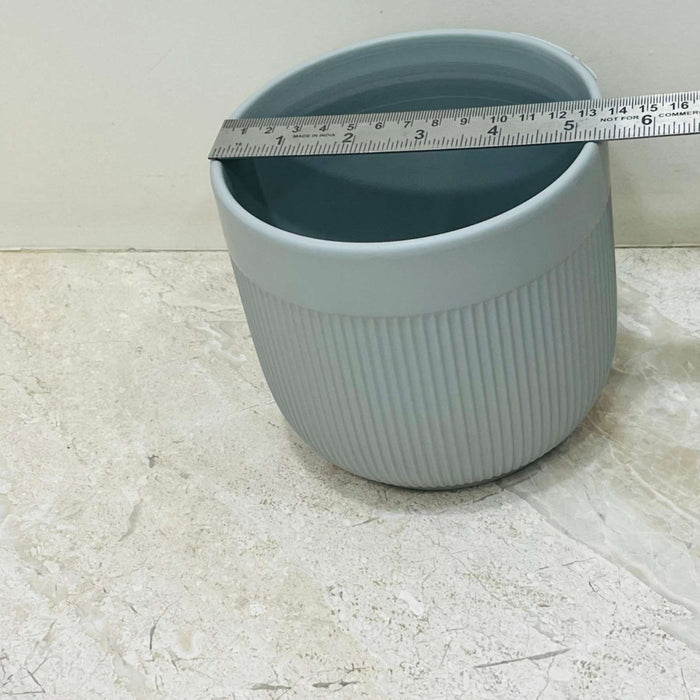 Minimalist gray ceramic pot with ribbed design