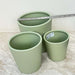 Three green ceramic pots for indoor plants