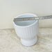 Minimalist textured ceramic planter in matte white for indoor plants.