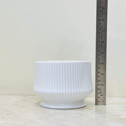 Modern white ceramic plant pot with vertical texture