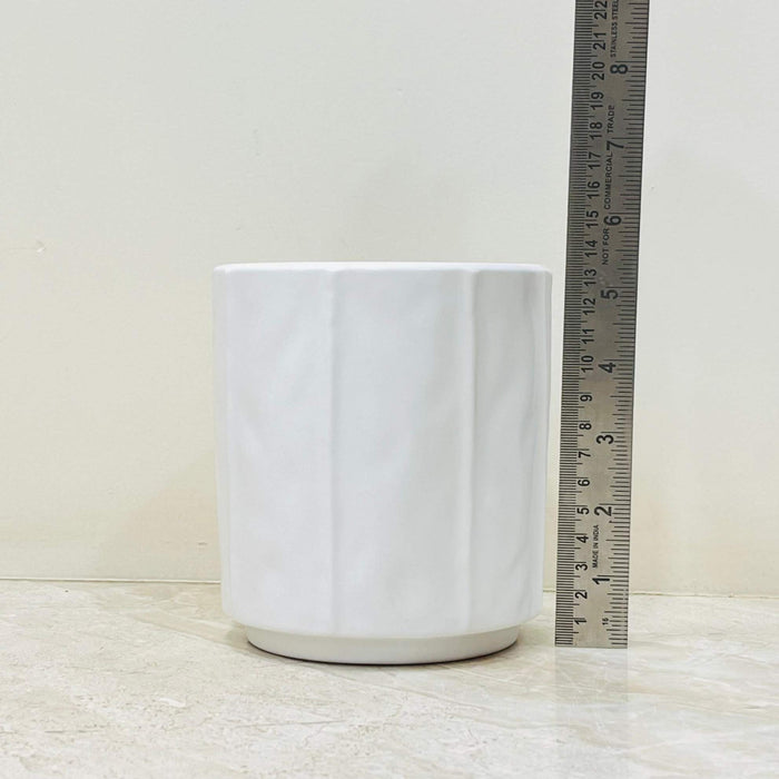 Minimalist white ceramic plant pot with geometric design