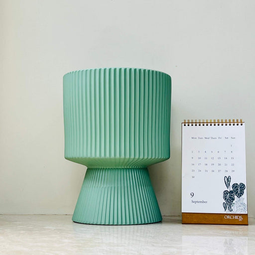 Mint green ribbed ceramic planter with flared base