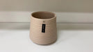 Modern beige ribbed ceramic pot for indoor plants