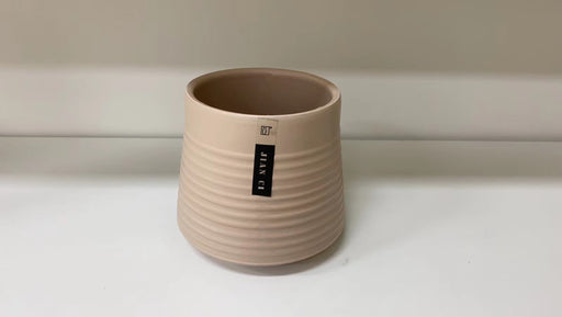 Modern beige ribbed ceramic pot for indoor plants