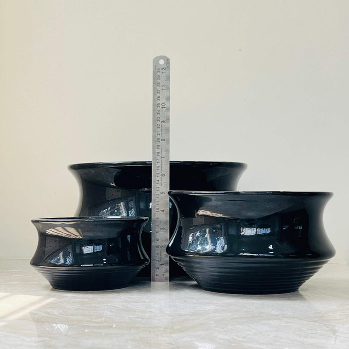 Sleek black ceramic indoor planters in three different sizes