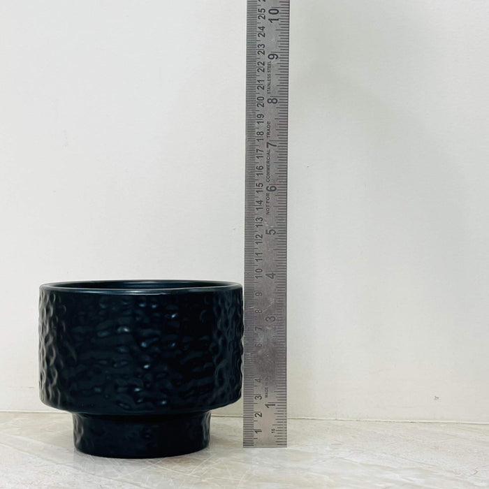 Modern black indoor plant pot with textured surface