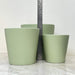 Green ceramic plant pots with a simple design