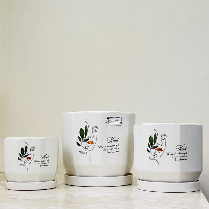 Artistic ceramic planters with inspirational text and leaf motif