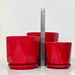 Trio of red ceramic pots with a sleek, geometric shape