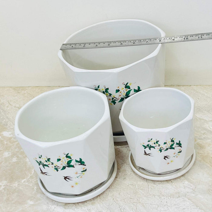 Modern white ceramic pots with vine and bird decoration