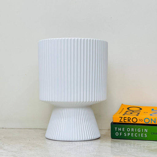 Modern white ribbed ceramic planter with a flared base