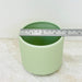 Pastel green ceramic plant pot with ribbed texture