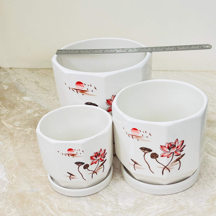 Decorative ceramic pots with matching saucers and lotus motif