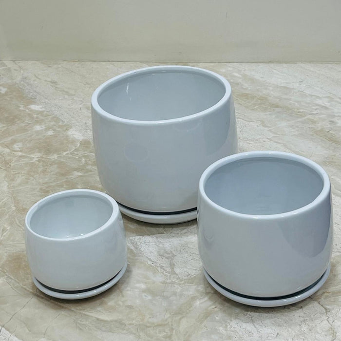 Minimalist white ceramic pot set with matching saucers