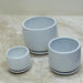 Minimalist white ceramic pot set with matching saucers