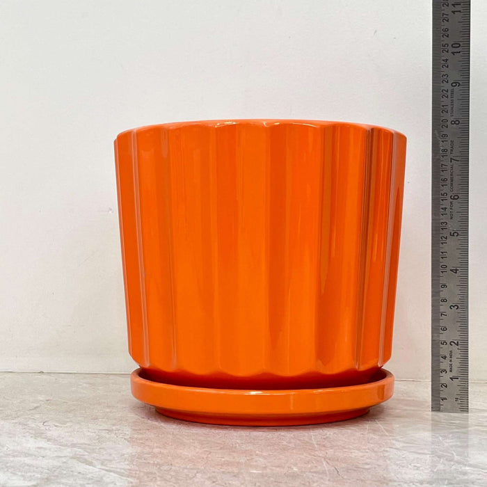 Vibrant orange ceramic pots with a modern ribbed finish