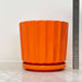 Vibrant orange ceramic pots with a modern ribbed finish