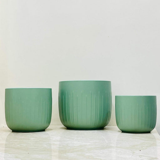 Sage green ceramic planter set with vertical ridges